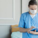 high angle male nurse with clipboard min