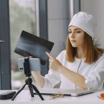 woman doctor recording vlog video about medicin min