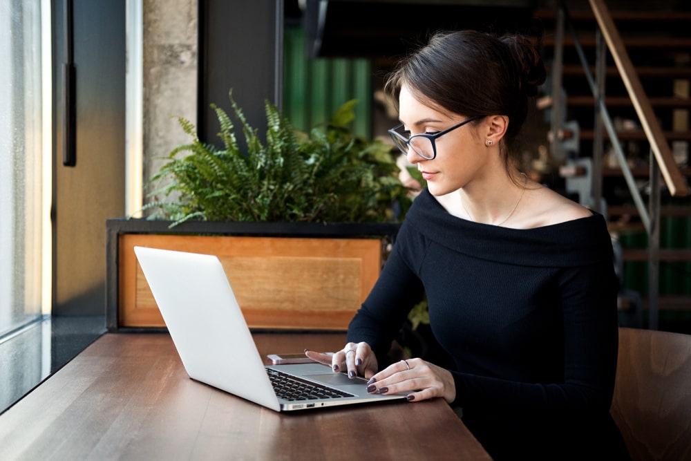 mulher com notebook para ilustrar texto sobre procurar emprego